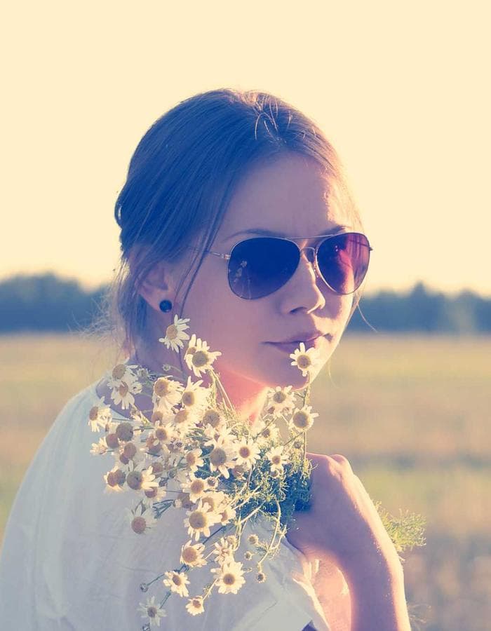 Woman holding wildflowers in golden light